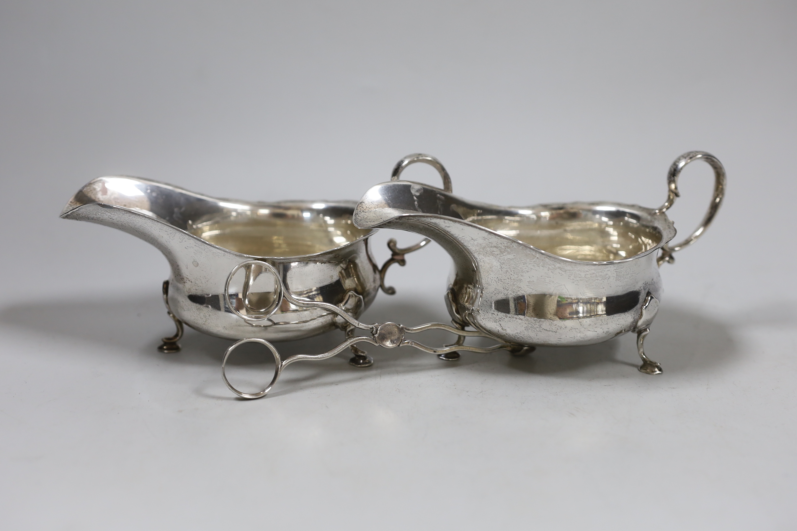 A pair of Edwardian silver sauceboats, Martin, Hall & Co, Sheffield, 1908 and a pair of 19th century silver sugar nips.